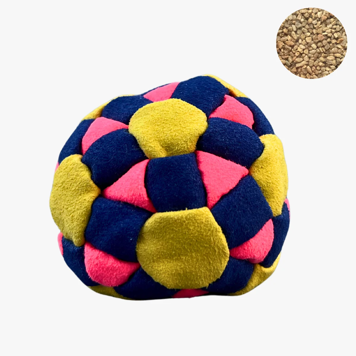 Ein gelb pink dunkelblauer Footbag liegt auf grauem Untergrund