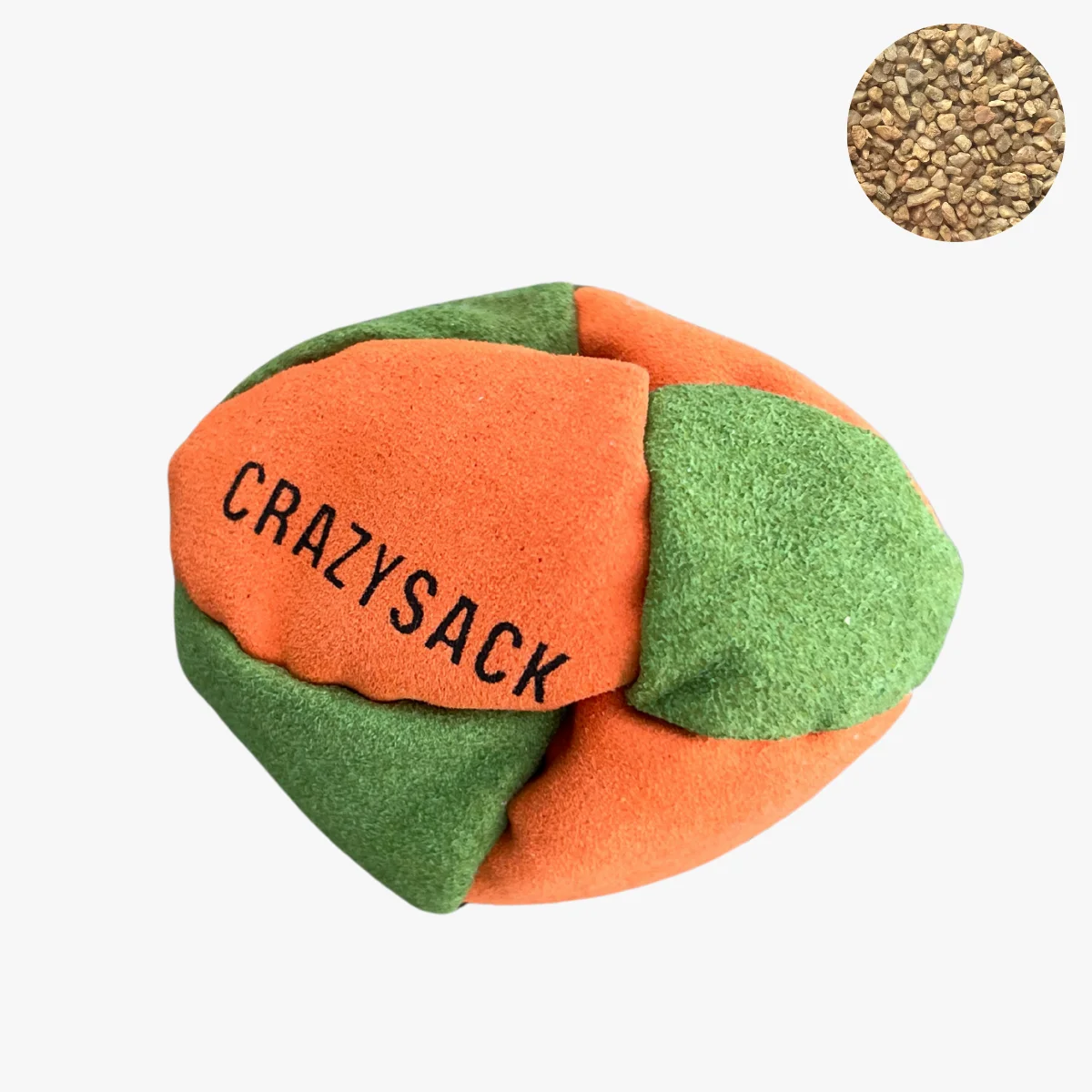 Ein orange grün Footbag liegt draußen auf einem Felsen